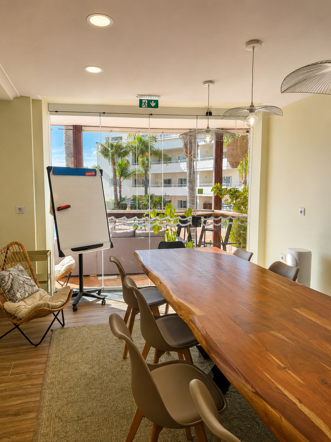 Meeting room with solid wood table, whiteboard and pool-view window at Vila Mós