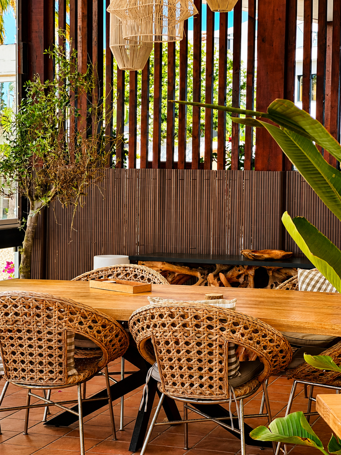 Shaded outdoor dining nook with rattan chairs